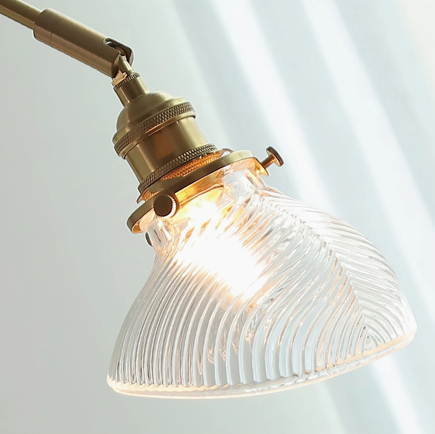 Rebell swing arm wall lamp full profile showing articulating arm extension, wood base, brass fittings and green glass shade