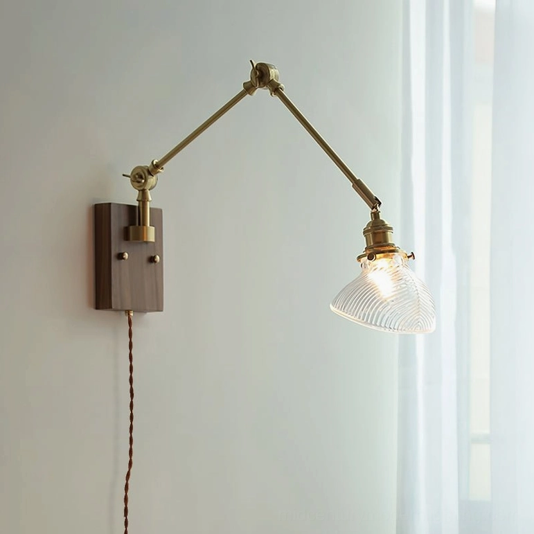 Rebell swing arm wall lamp with walnut wood finish and clear ribbed glass shade, front view in bright home interior