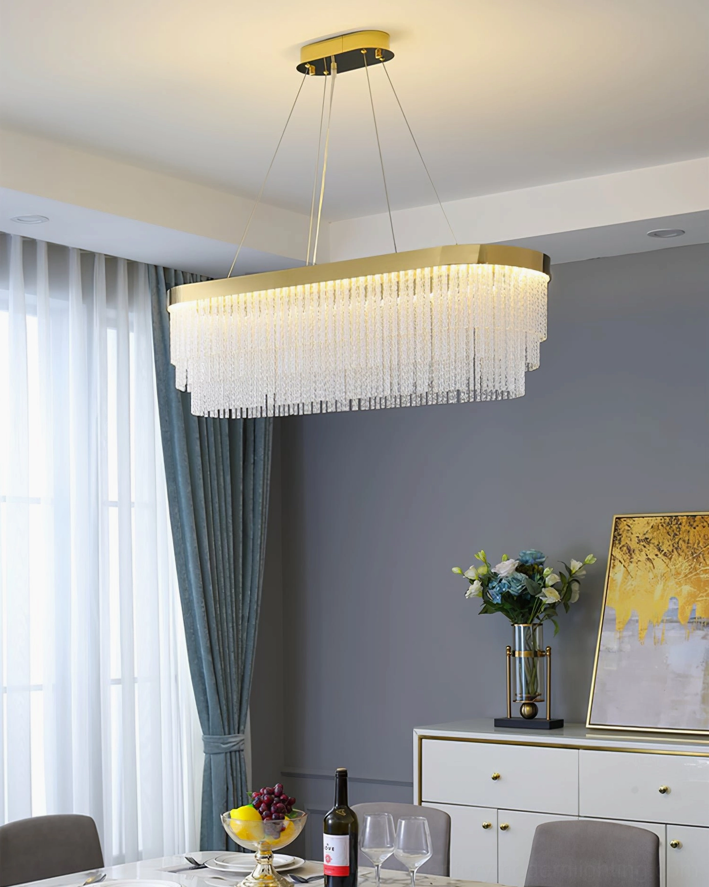 Linear rectangular crystal chandelier with gold hardware in modern styled dining room