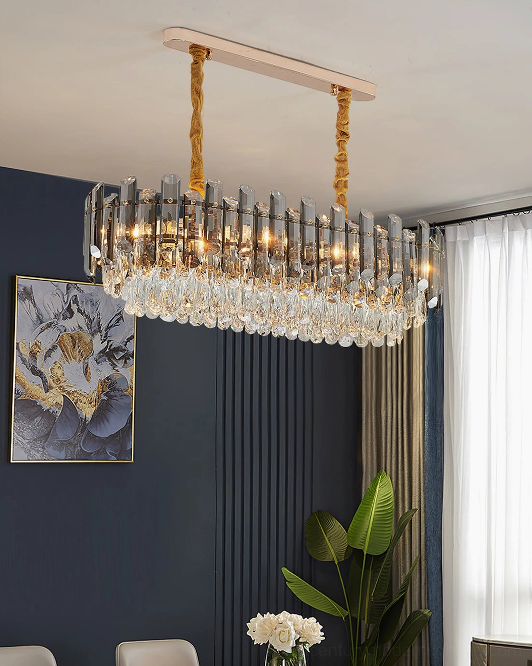 Rectangular linear crystal chandelier in modern dining room with gold hanging hardware and clear crystal trim
