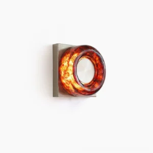 Red circular wall sconce with warm integrated LED, studio product photography with minimal white background