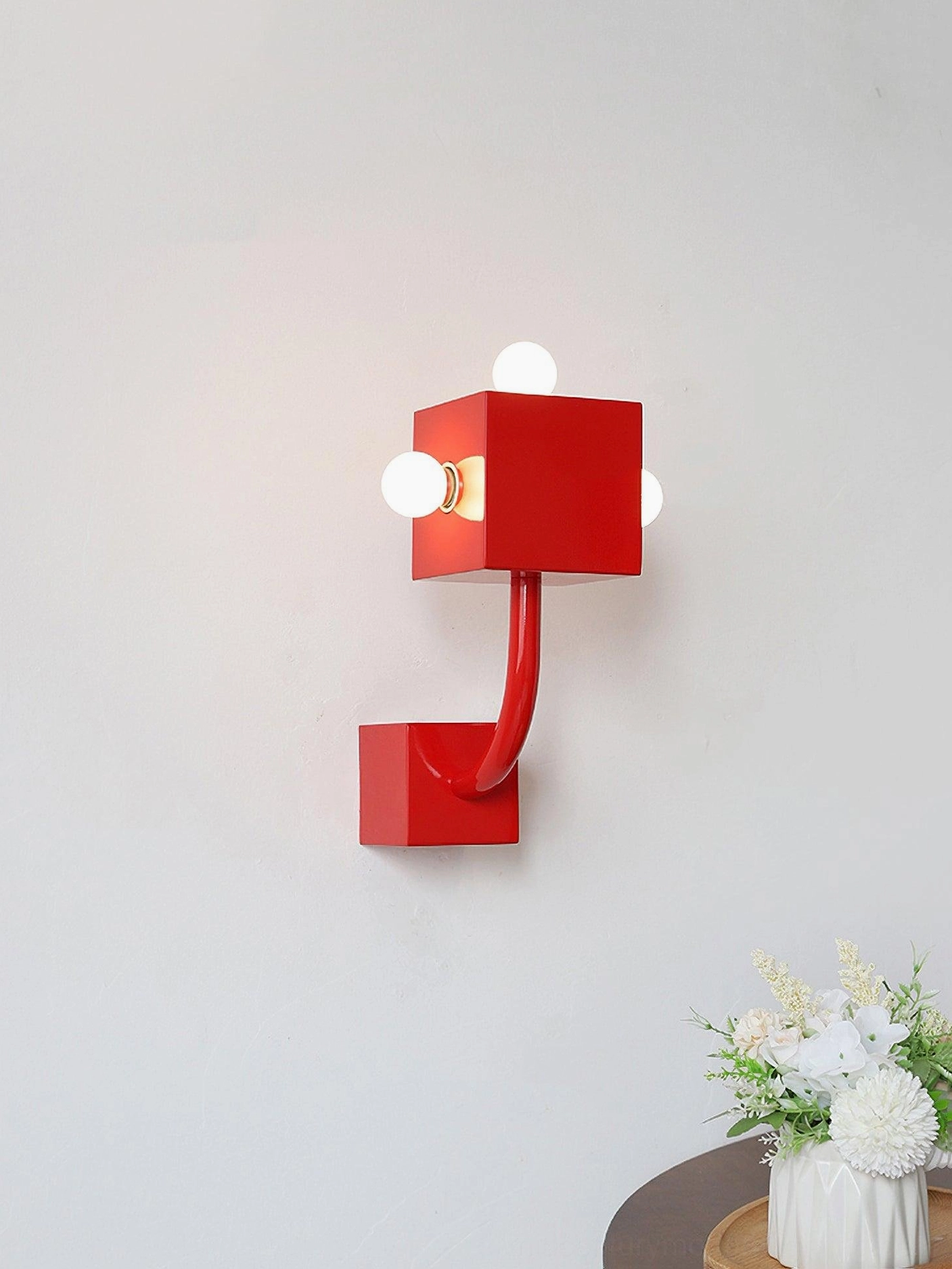 Red cube wall lamp interior bedroom setting three-quarter angle flower decor