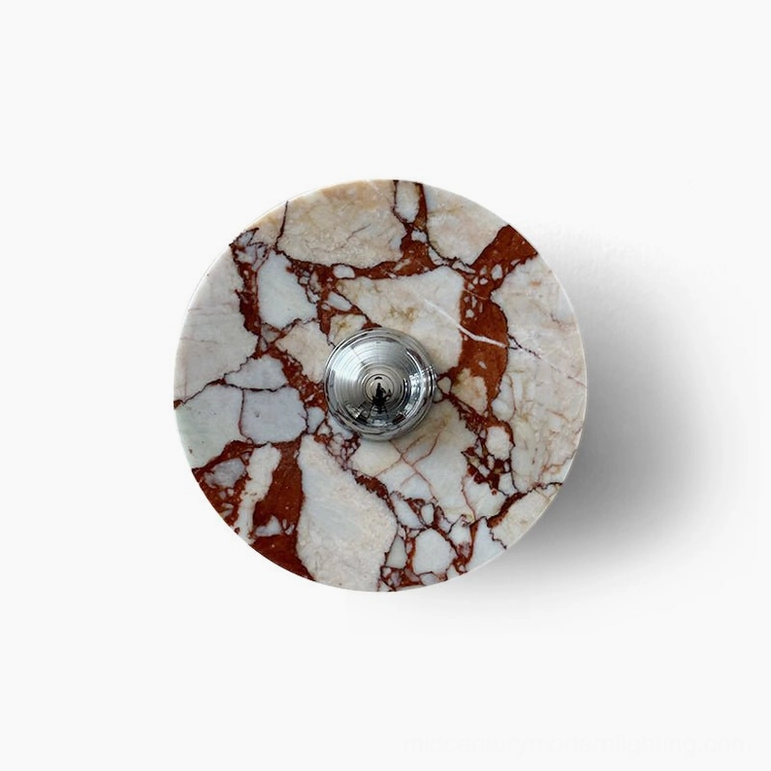 Red marble geometric wall lamp with chrome accent mounted on wall demonstrating mid-century modern aesthetic