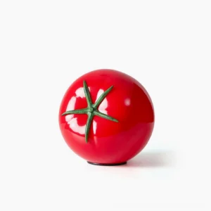 Tomato-shaped red glass table lamp with green calyx detail on white background, front view