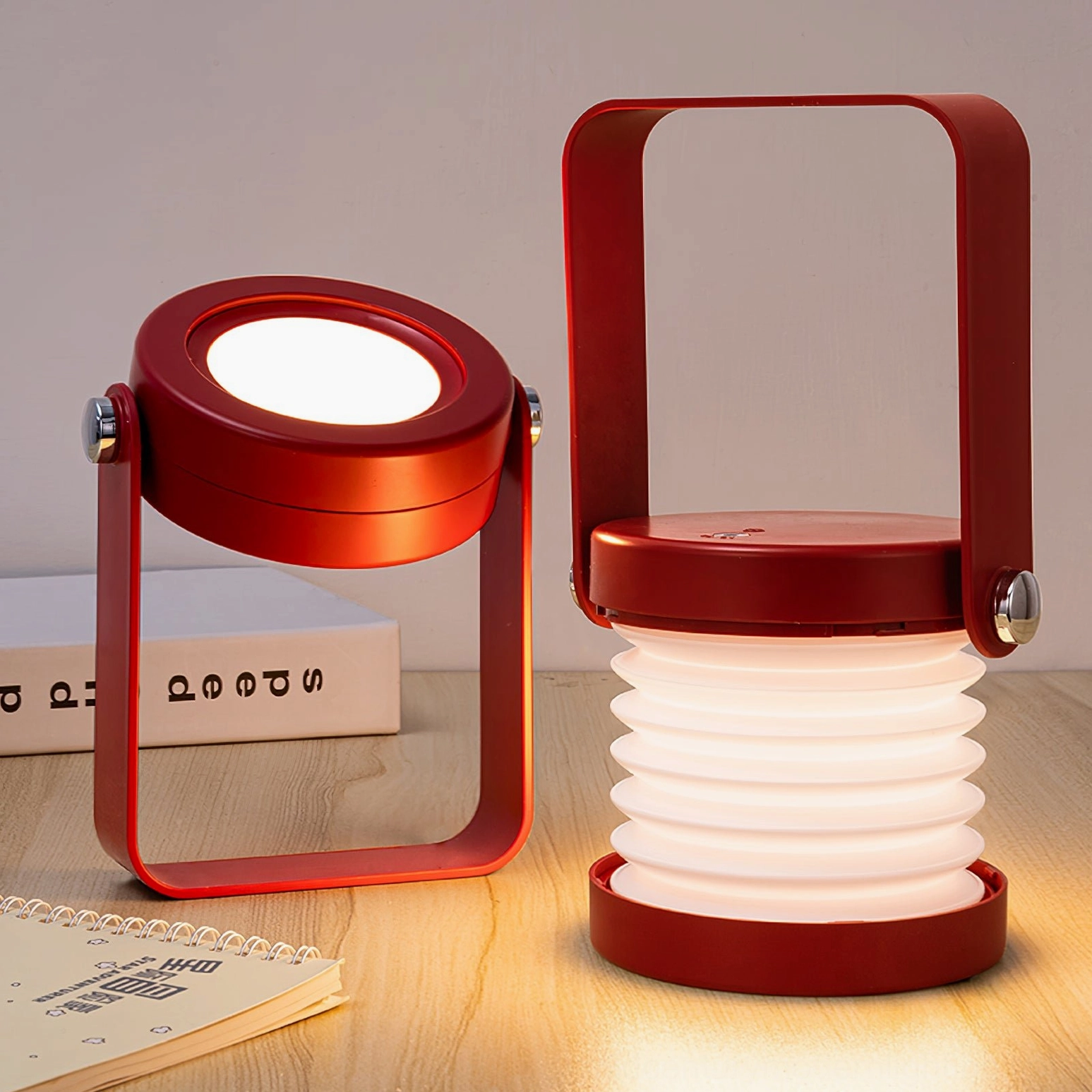Pair of lantern table lamps with red and wood color finish on study desk, creating warm atmospheric lighting for workspace