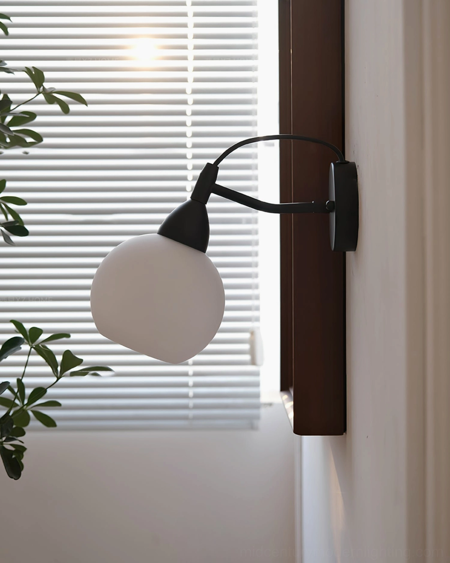 Reese black wall-mounted lamp side profile with louvered window and indoor minimalist setting
