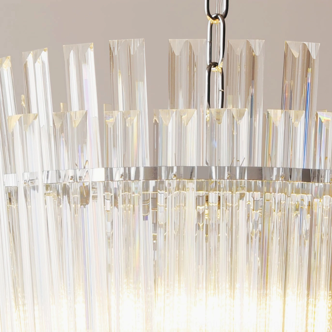 Low-angle close-up of Regina chandelier emphasizing tiered glass construction and bright illumination effect