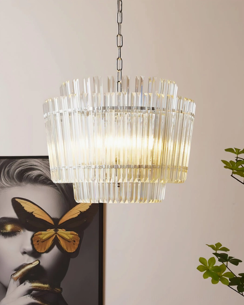 Illuminated Regina chandelier displaying cascading crystal glass tubes with soft warm white light in residential setting