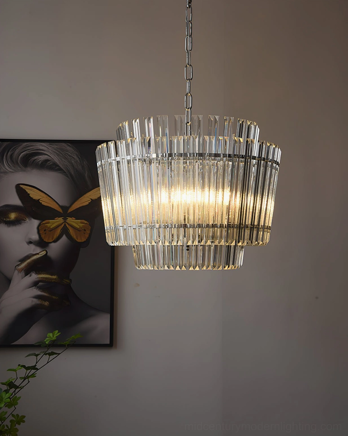Regina modern chandelier hanging in residential interior with butterfly wall art and cascading glass creating cozy ambiance