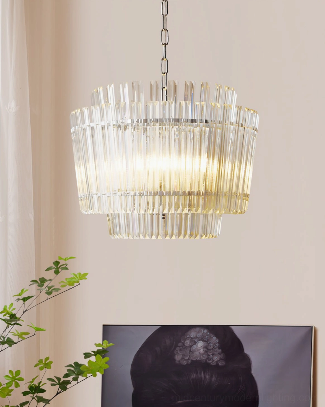 Regina tiered glass chandelier installed in modern home interior with wall art creating warm atmospheric light