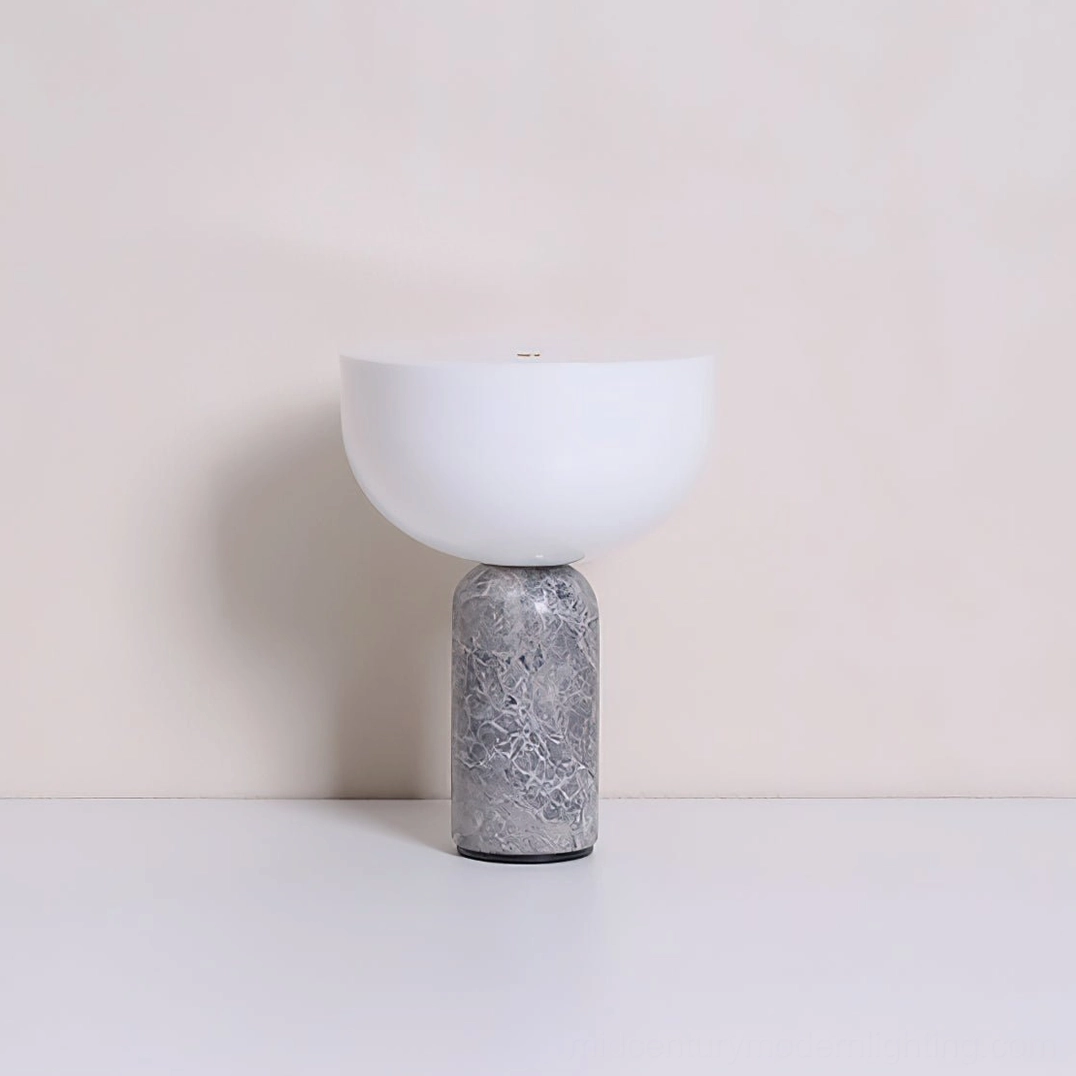 Renard marble lamp styled on floating shelf with art books and minimal accessories