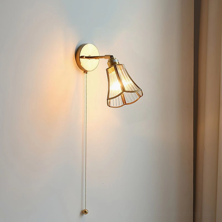 Compact Rennes wall lamp brass and glass side angle with warm glow