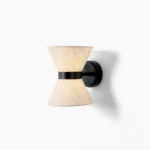Renwick hourglass wall sconce with beige linen shade and matte black metal frame, front view on white background