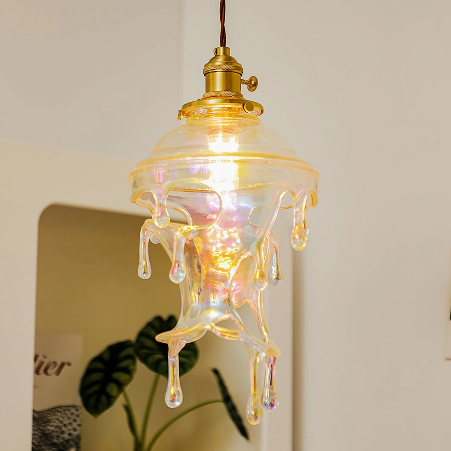Handmade resin water droplets pendant suspended in modern home entryway with botanical decor