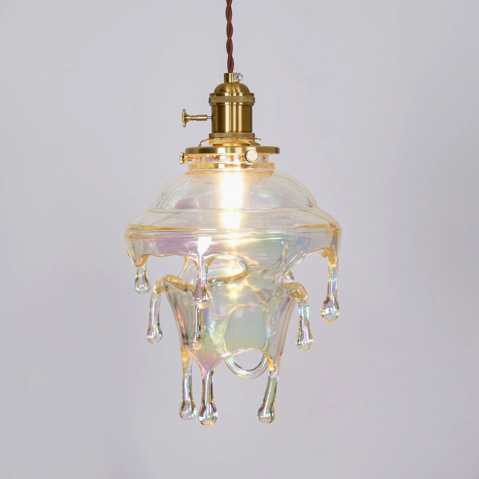 Resin pendant lamp hanging in soft natural light, showcasing warm diffusion through shade