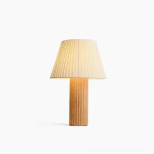 Respira pleated fabric table lamp with natural wood ribbed base frontal view on white background, mid-century modern design