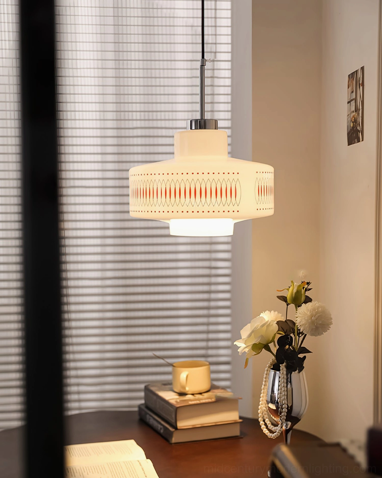 Retro Circle pendant suspended above desk area with flower vase and books, mid-century modern workspace lighting
