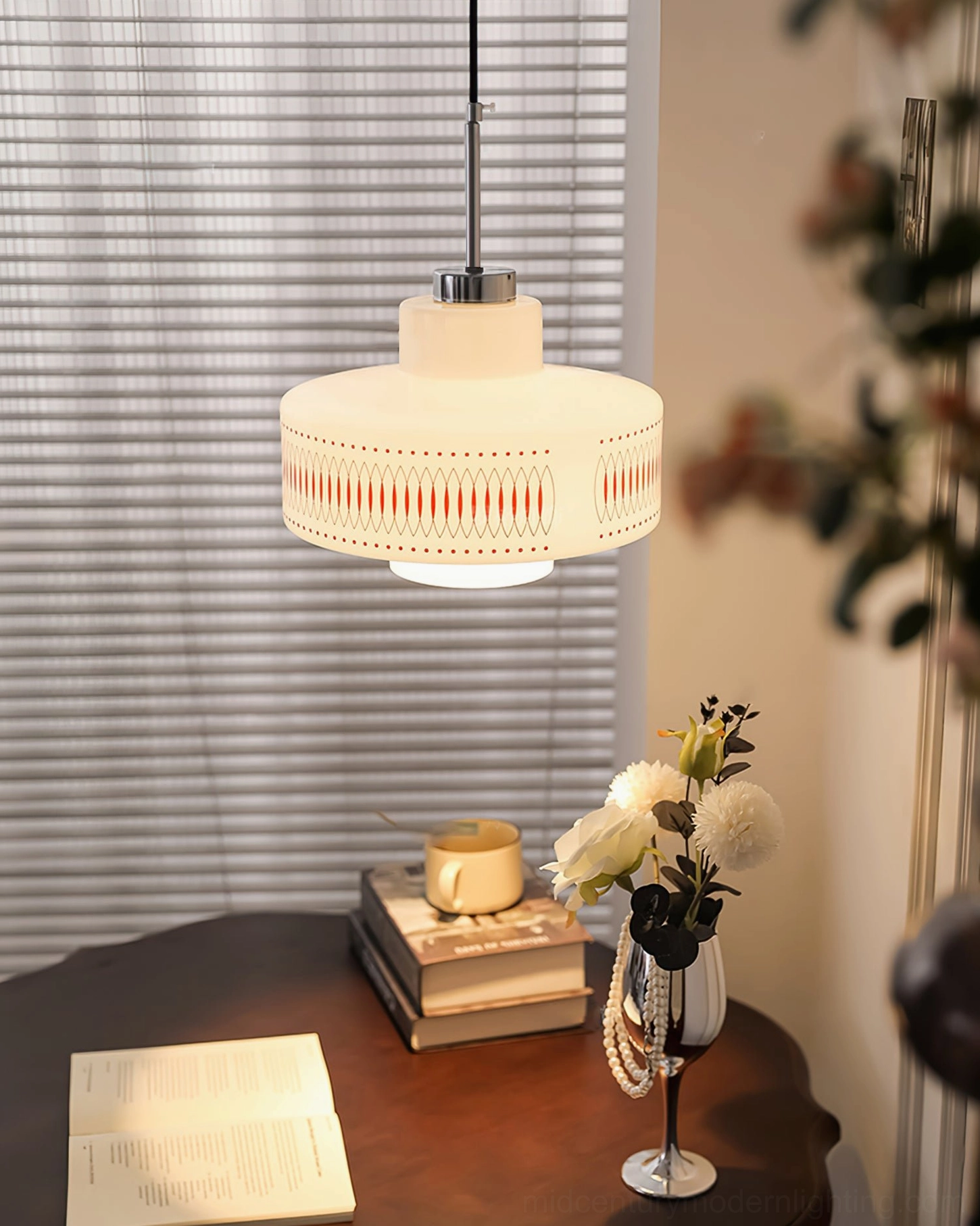 Retro Circle pendant light against warm neutral wall background, showcasing full geometric pattern and chrome finishing
