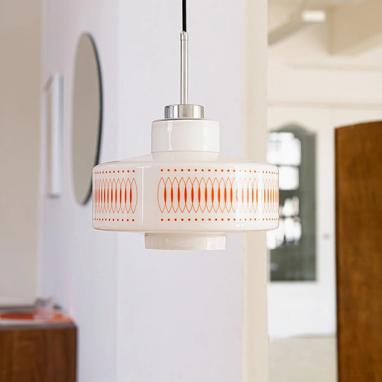 Single Retro Circle pendant suspended in contemporary entryway with polished chrome hanging rod, 1970s-inspired geometric lighting