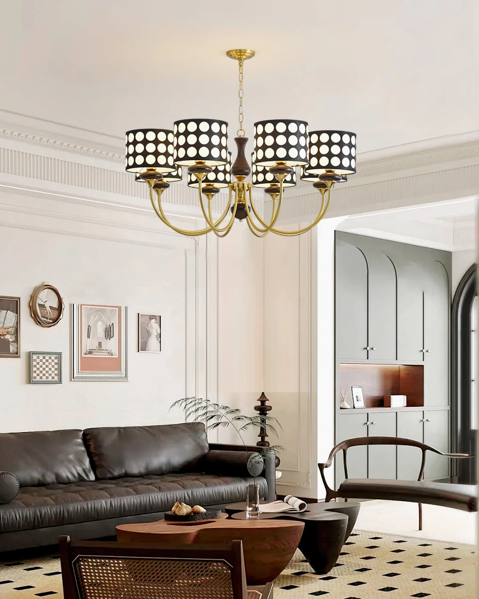 Retro elegant polka dot chandelier with black shades and luxury gold metalwork, vintage leather sofa interior design