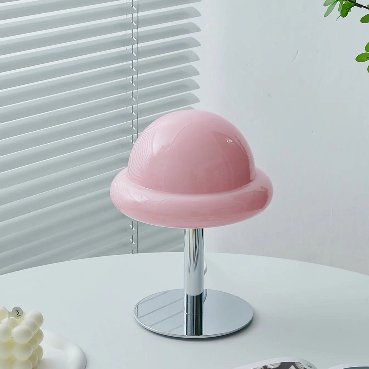 Orange glass mushroom lamp with integrated LED showing warm light diffusion and sculptural silhouette