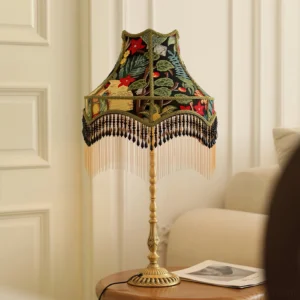 Retro peony table lamp displayed in French-inspired living room setting with brass pole and patterned fabric shade with tassel trim