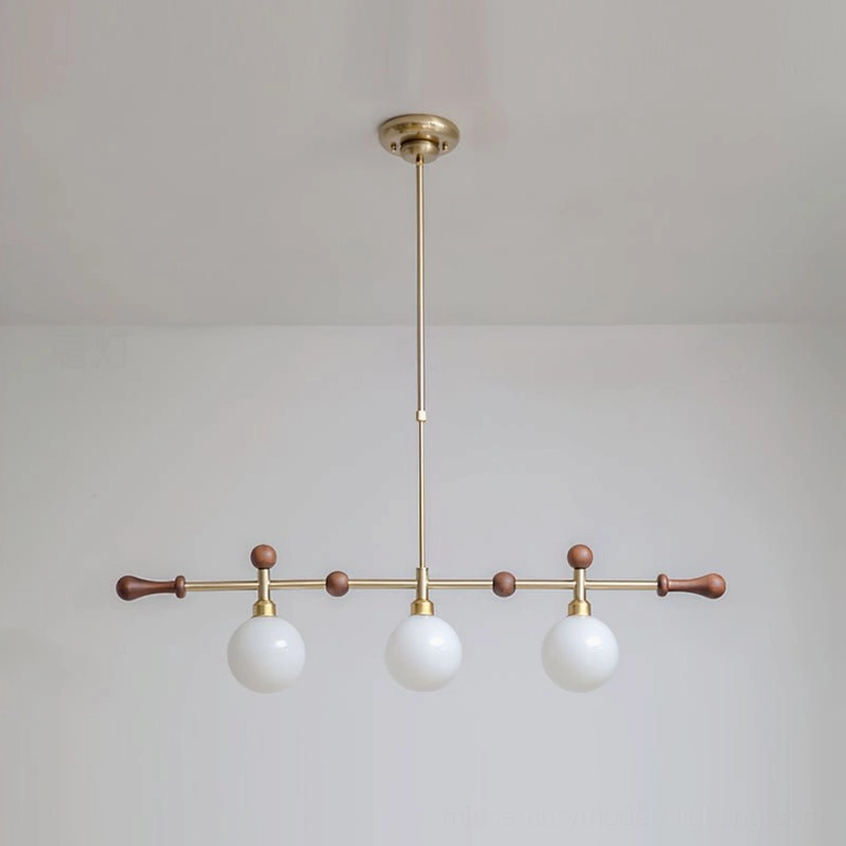 Reya 3-head linear chandelier in brass gold and walnut, compact mid-century modern lighting fixture for dining and kitchen spaces