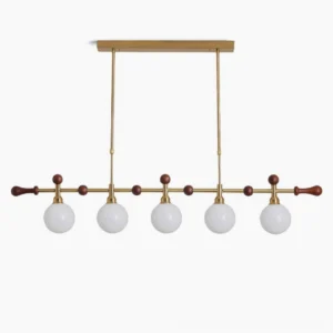 Reya linear chandelier with 5 glass globe shades in brass gold and walnut wood, front studio view showing mid-century modern design details