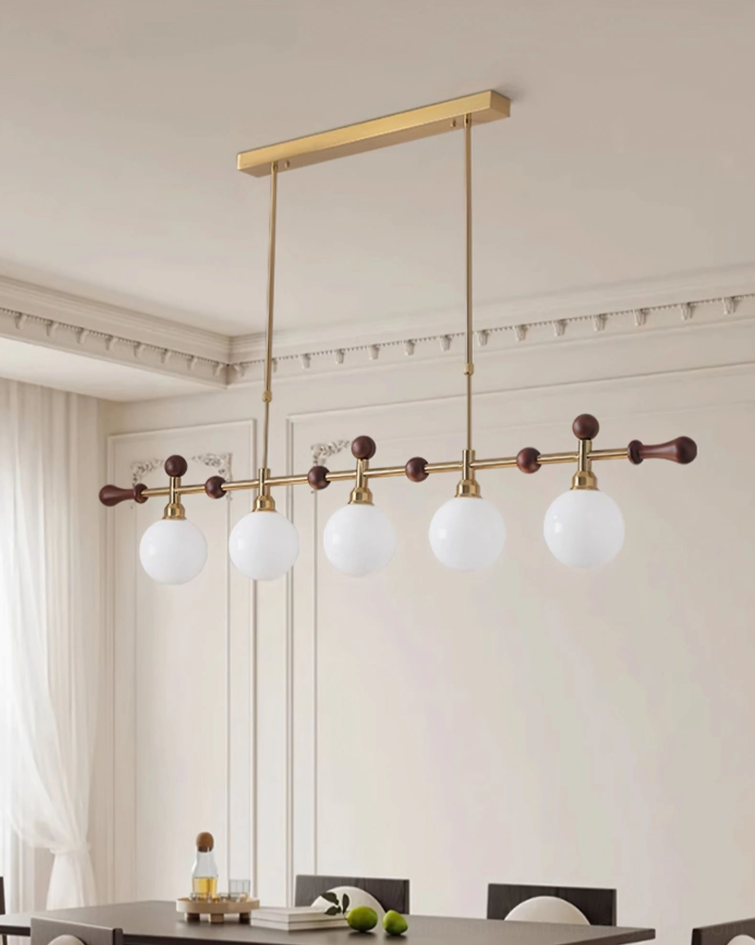 Reya linear chandelier with milky white glass shades and brass gold hardware in minimalist dining room with crown moulding walls