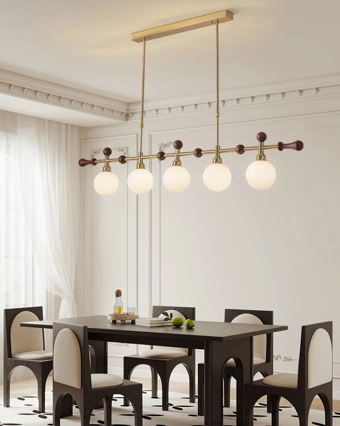 Reya linear chandelier with 5 unlit frosted glass globes suspended in modern dining space with dark wood furniture and architectural details