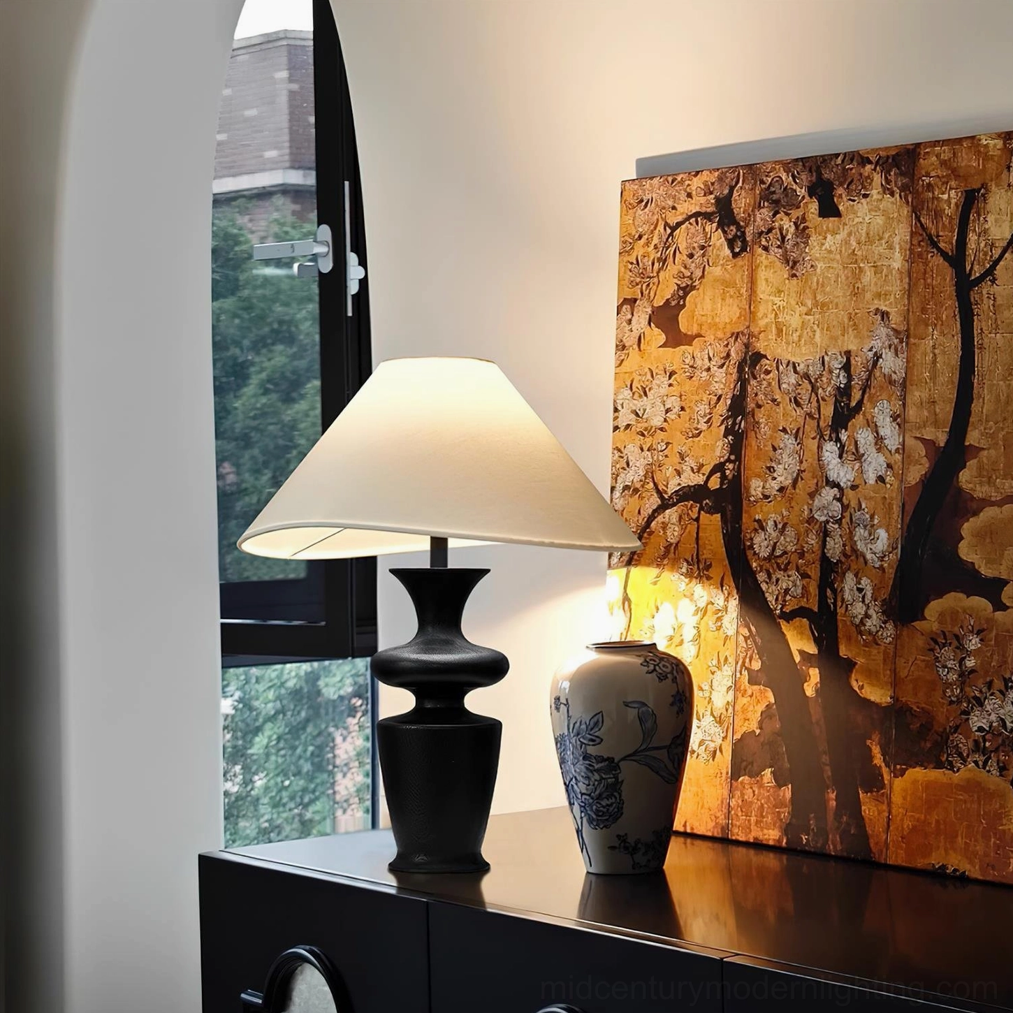 Rhodes mid-century lamp in home setting demonstrating warm ambient lighting and interior design versatility