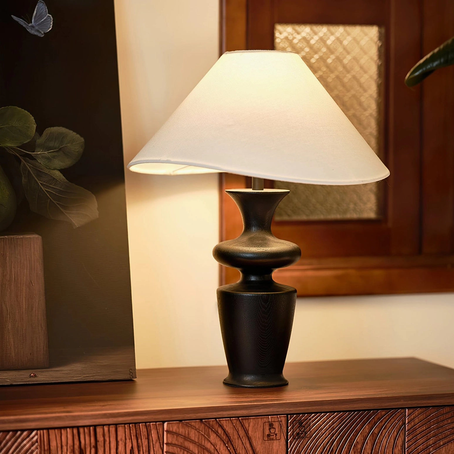 Rhodes table lamp creating warm ambient lighting on wooden side table in contemporary home interior