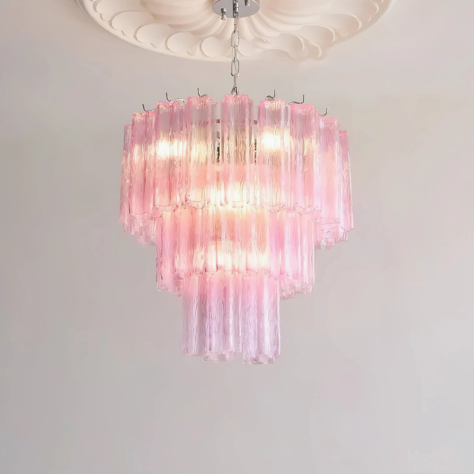 Light pink gradient tiered chandelier displaying soft warm lighting ambiance