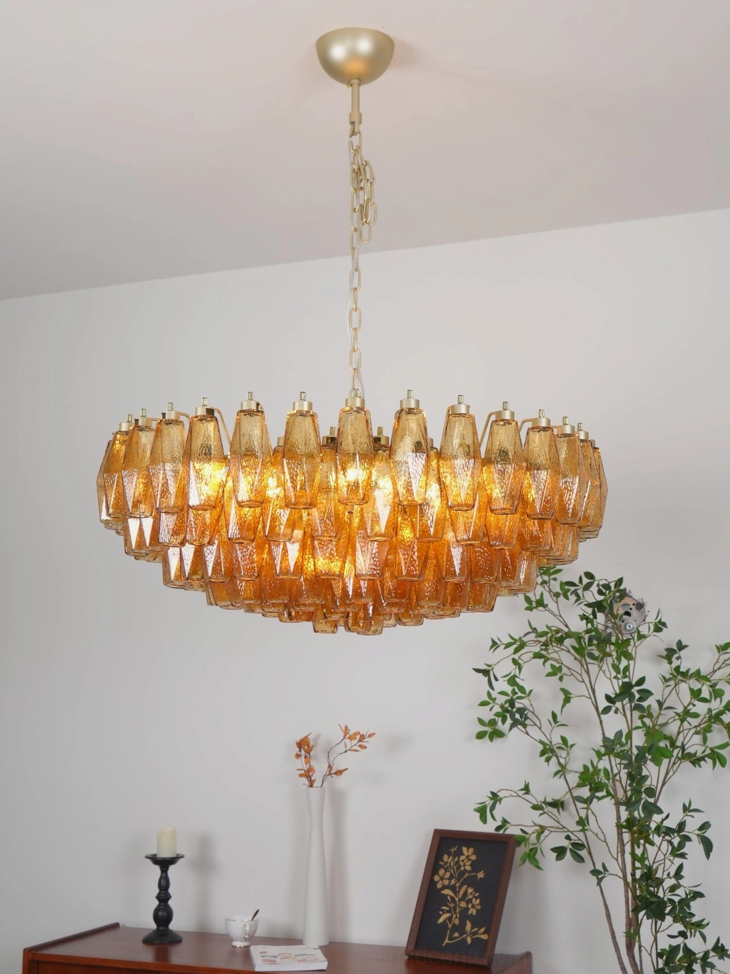 Amber glass rhombus chandelier as focal point in modern dining or living space interior design