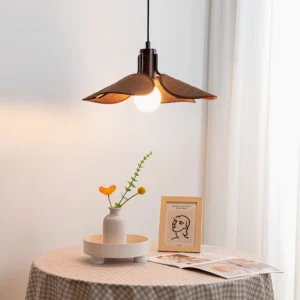 Single Riankh bohemian pendant lamp suspended above minimalist dining table with checkered tablecloth, warm ambient lighting