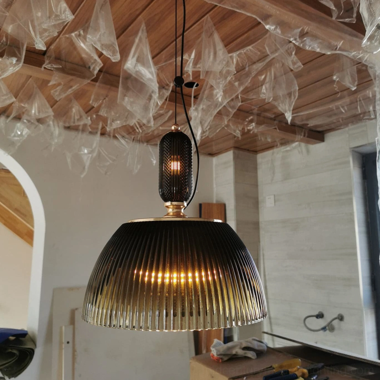 Hanging pendant lamp with textured ribbed dome creating sophisticated ambient lighting in dining area