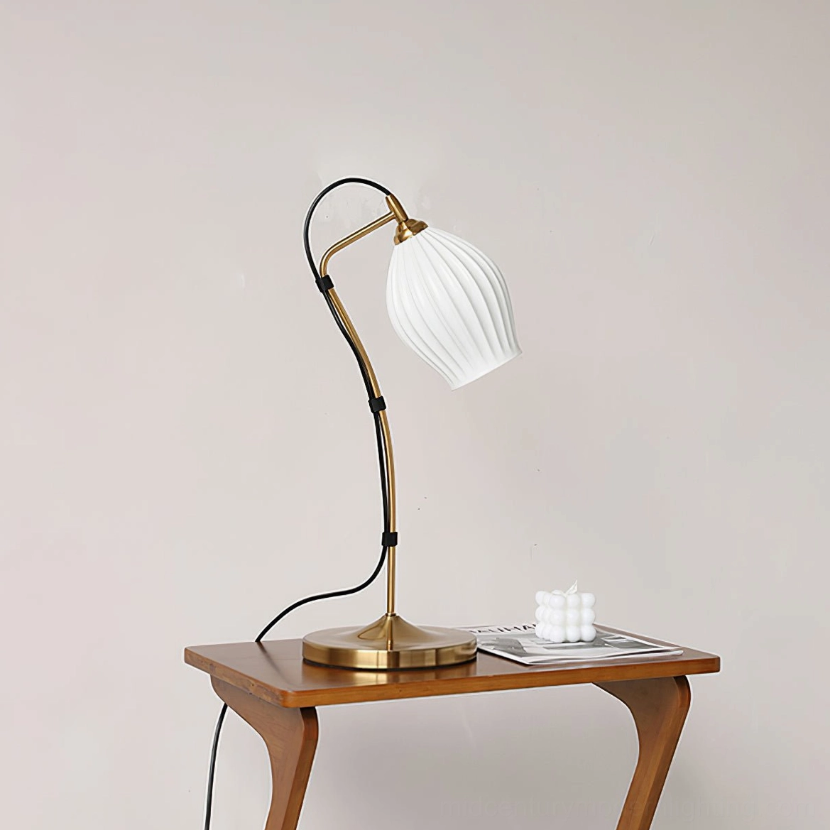 Ribbed ceramic table lamp warm illuminated state with glowing ceramic shade and soft ambient light