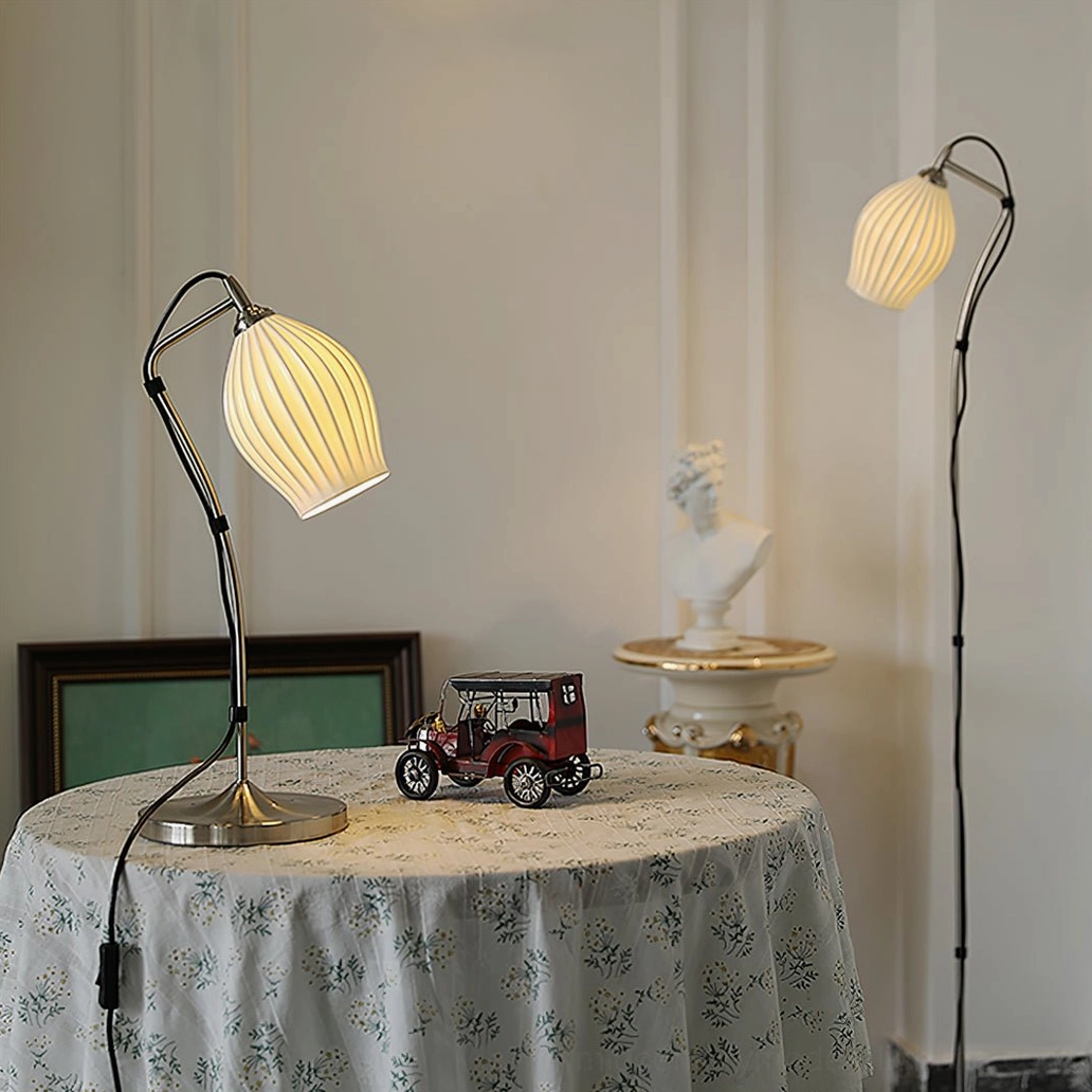 Matching ribbed table lamp and floor lamp pair in vintage home dining corner with toy car and bust sculpture