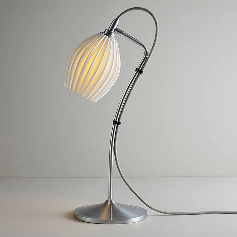 Ribbed ceramic table lamp size comparison or scale reference in home interior setting
