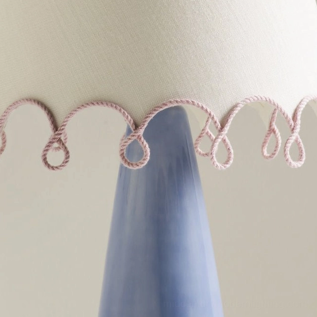 Detailed close-up side view of pink twisted rope scalloped trim on lampshade edge