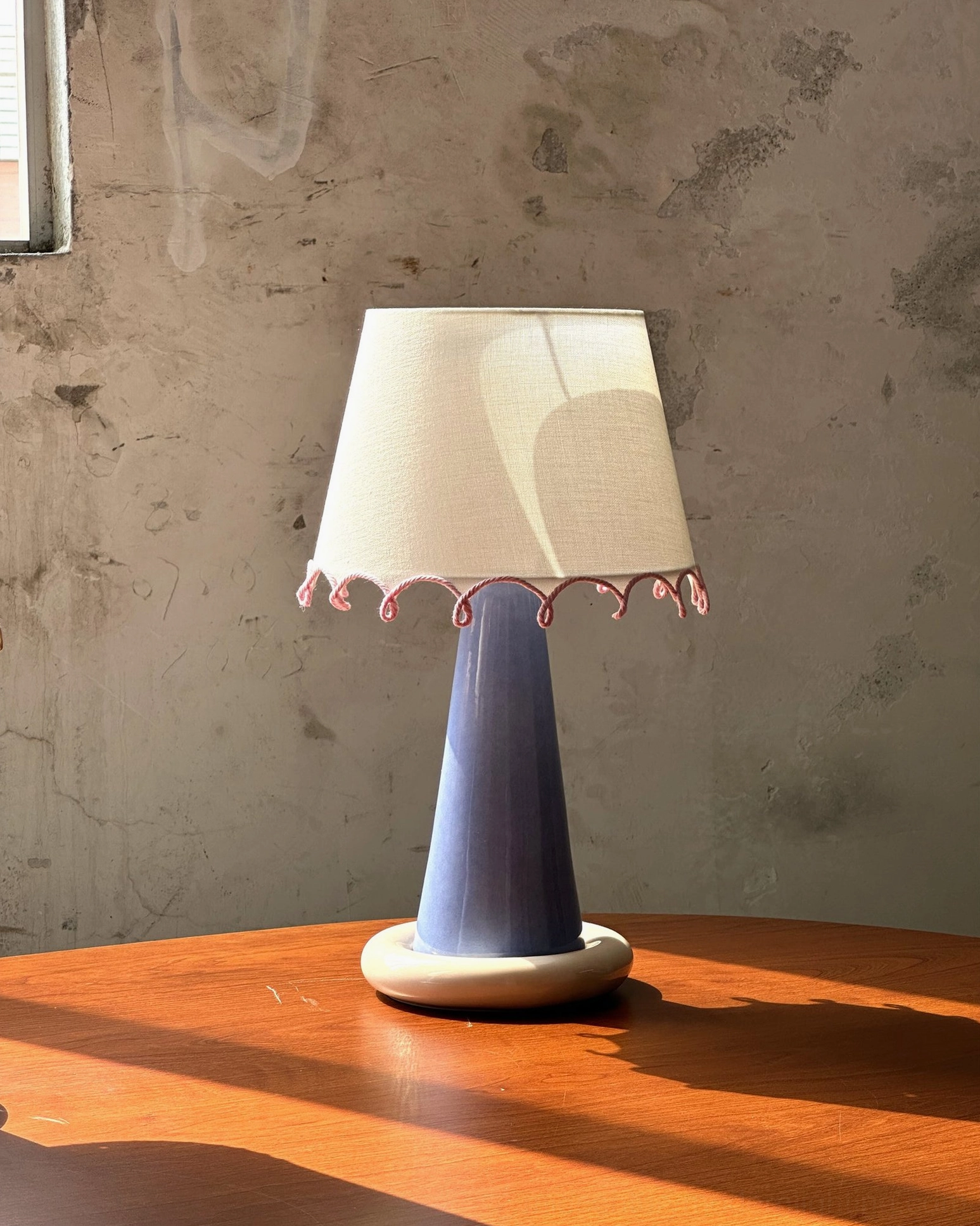 Alternative view of ribbon table lamp emphasizing fabric shade construction and decorative rope trim details