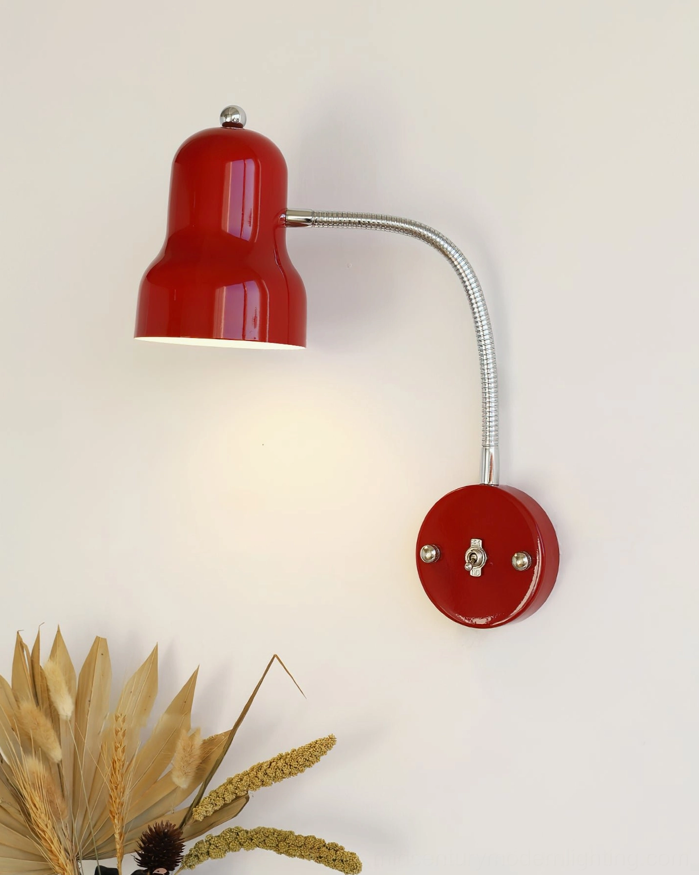 Compact red industrial wall lamp with silver flexible gooseneck and integrated base controls, studio angle