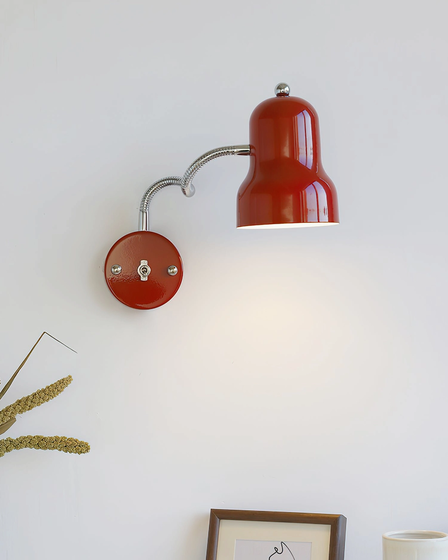 Dual-joint red industrial wall lamp with bending articulated arm, three-quarter side profile home display
