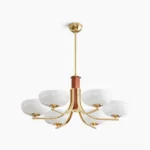 Six-arm Rico mid-century modern chandelier with brass gold finish and opal white glass shades, overhead studio view