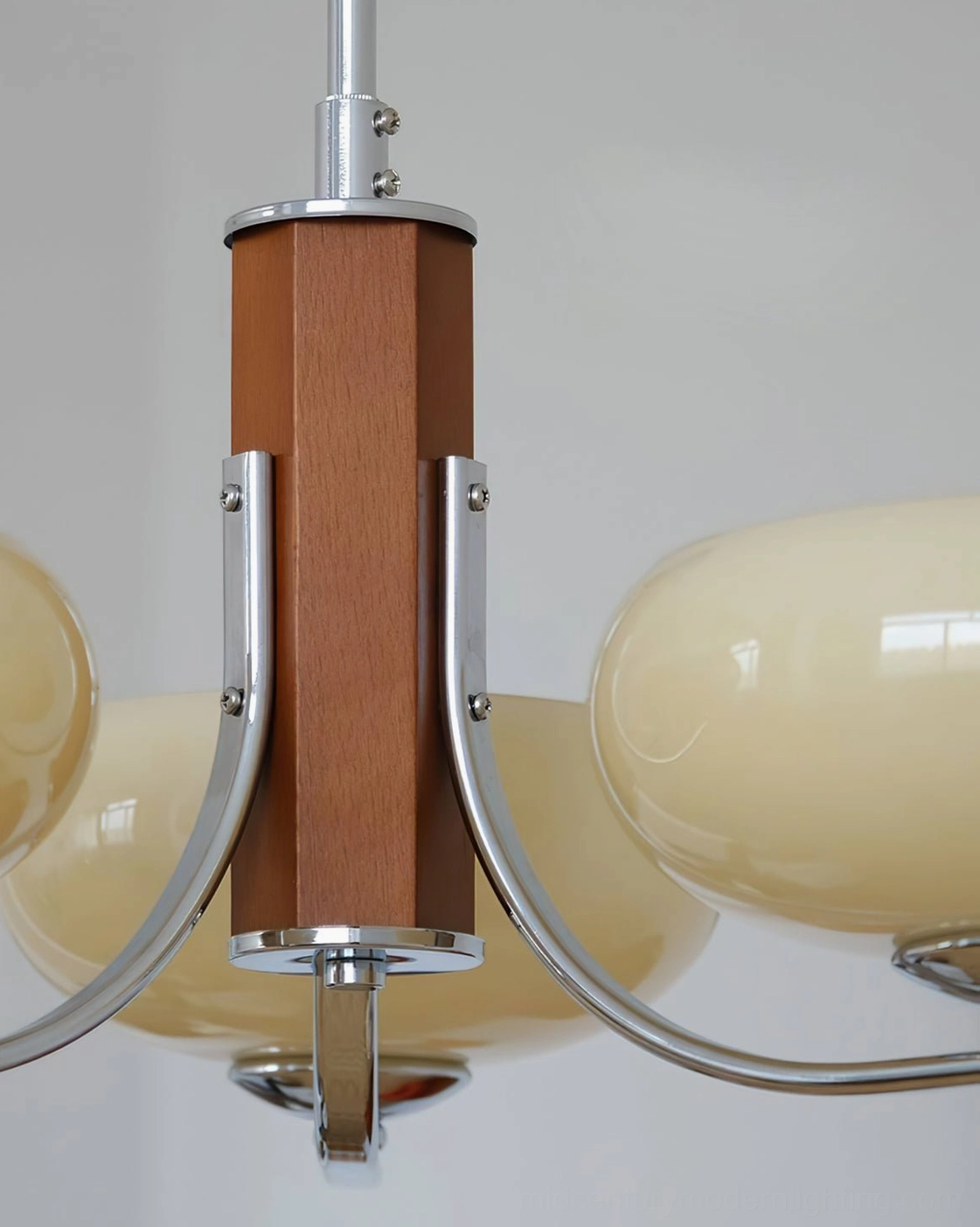 Chrome finish Rico chandelier hardware detail with brown wooden central column, overhead view