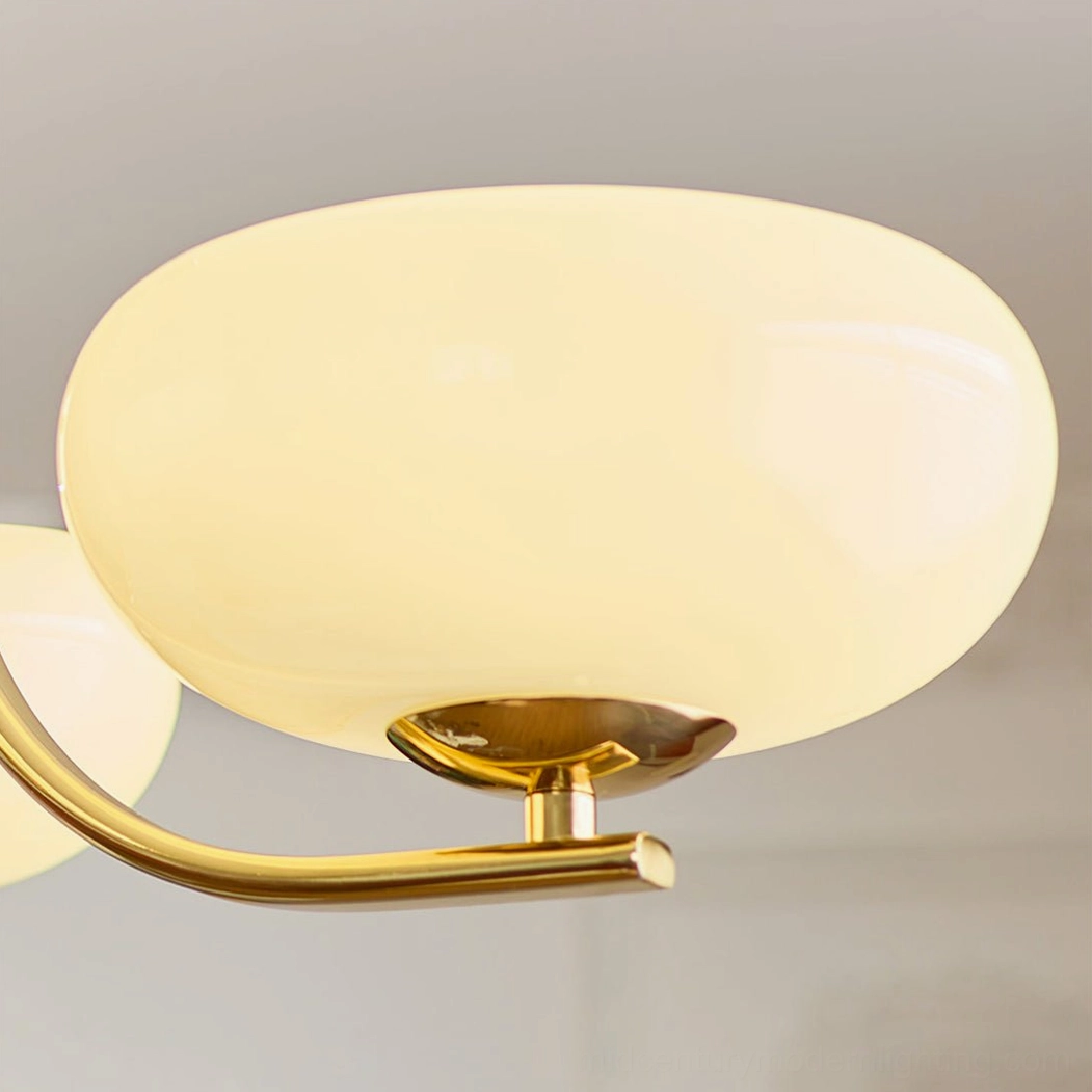 Close-up Rico lamp assembly detail with opal white glass shade and brass gold metal base