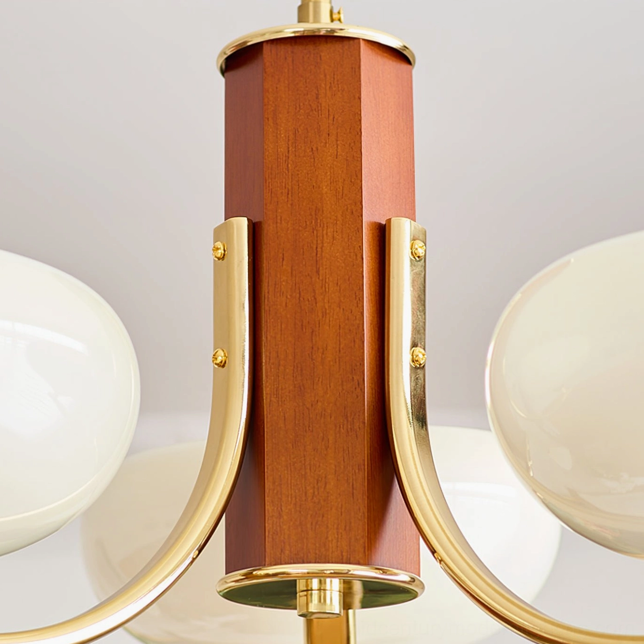 Rico chandelier hexagonal wood column with brass gold mounting brackets, overhead detail shot
