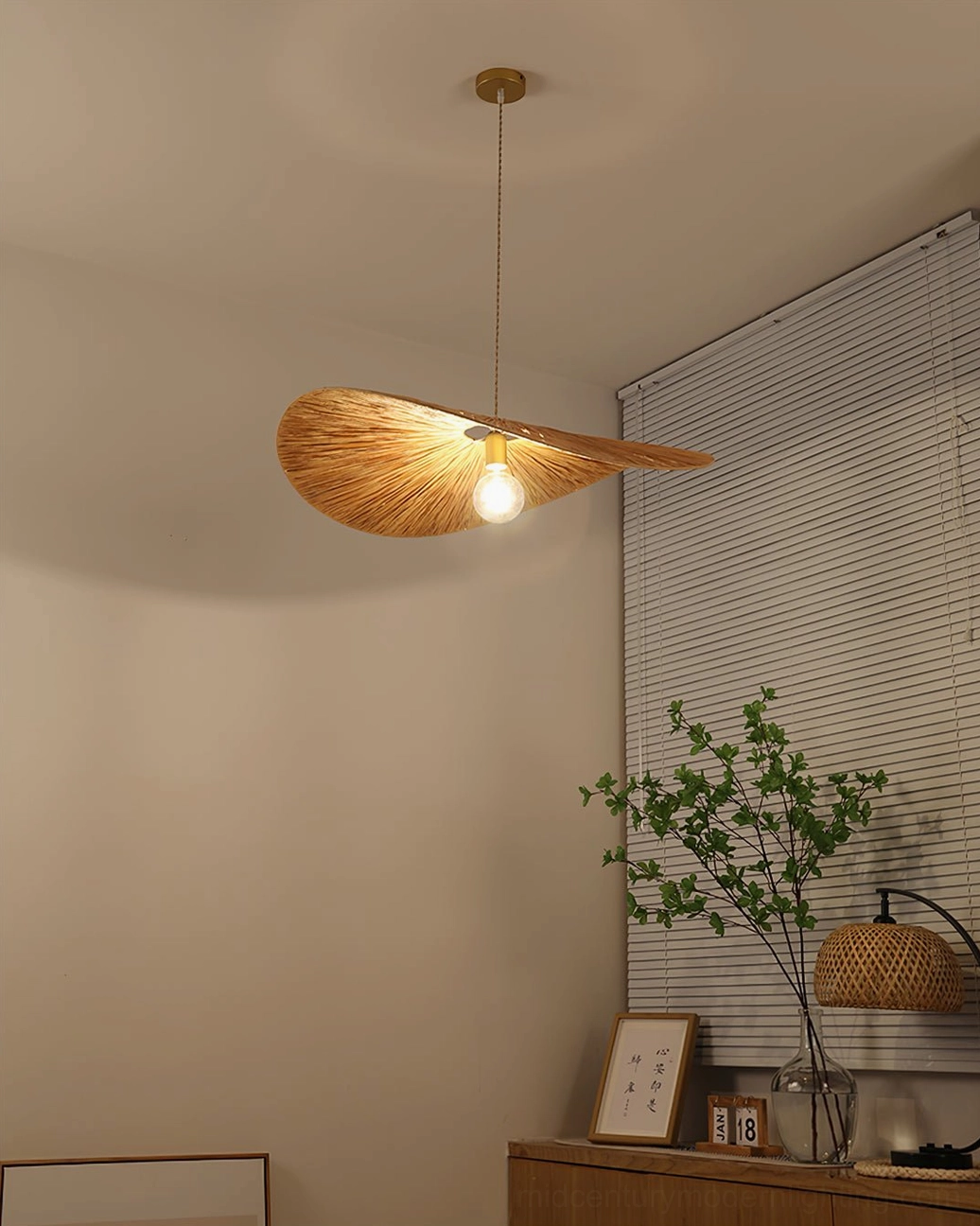 Ridotti natural rattan pendant lamp demonstrating warm golden hour lighting and shadow casting through hand-woven shade