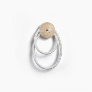 Rigel travertine wall lamp with double illuminated rings and beige stone base, front overhead view on white background