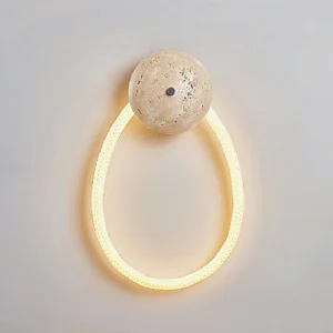 Rigel wall lamp with warm glowing rope light and travertine base creating soft ambient illumination